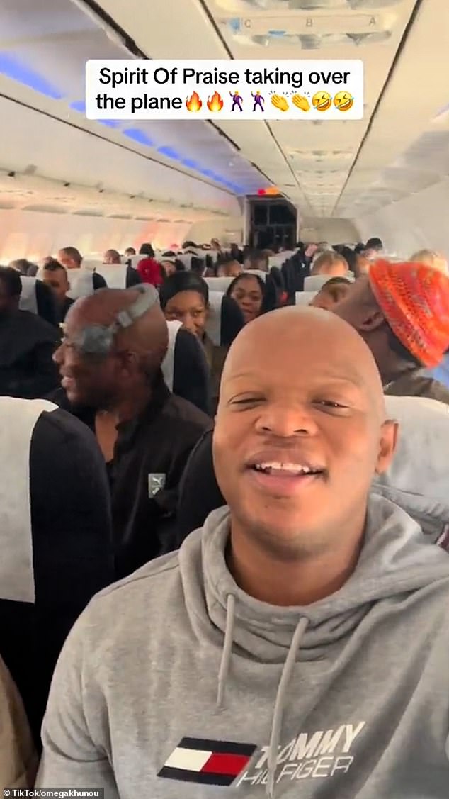 In a video that went viral on social media, Omega Khunou (pictured wearing a gray sweater), a singer in the group, filmed herself and other Spirit of Praise members singing their song Moy'Oyingcwele on board a crowded plane.