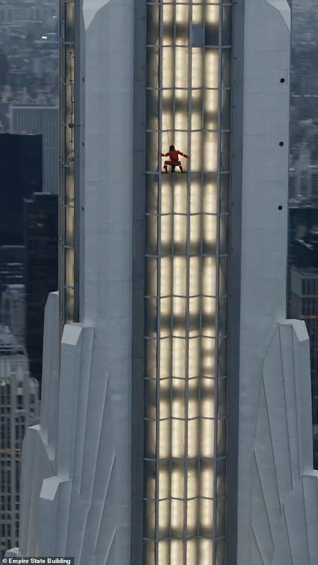 The actor and singer were seen in risqué images as he traversed the side of the iconic building in a red jumpsuit