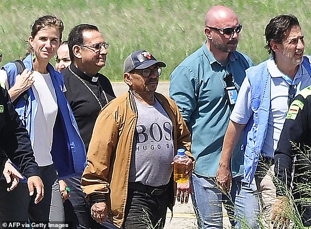 Luis Manuel Diaz, center, steps out of a helicopter after being rescued in Valledupar