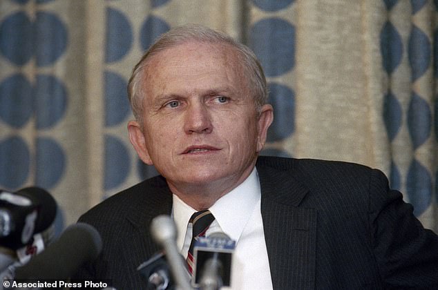 Frank Borman ponders a question at a news conference in Miami, June 3, 1986