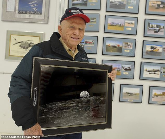 Apollo 8 commander Frank Borman poses in Billings in 2013 with a photo of Earth taken as his spacecraft orbited the moon in 1968