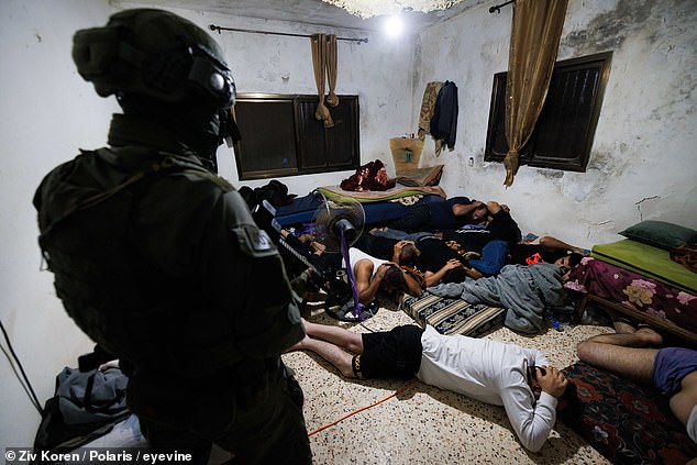 Hamas terrorists were seen lying face down with their hands on their heads during the raid