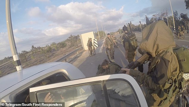 Hamas gunmen force a man into a car and taunt him during their terror campaign