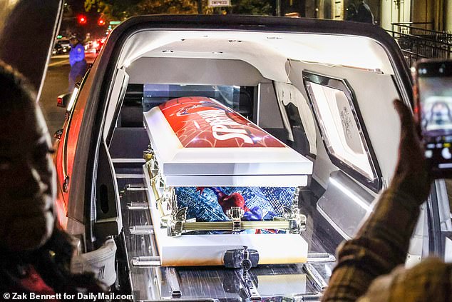 The Spiderman-obsessed boy's coffin was painted in the theme of his favorite superhero, pictured being loaded into a hearse