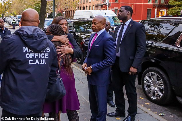 New York Attorney General Letitia James hugs Kamari Hughes' mother Taquunda (center) after New York City Mayor Eric Adams comforts her during the solemn funeral service