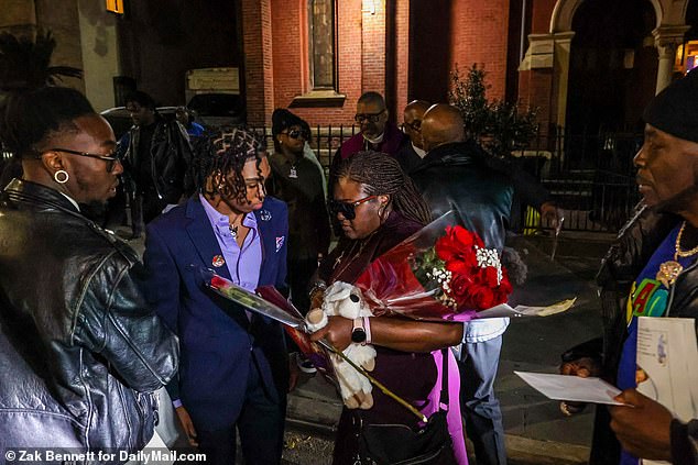 Taqunda Hughes watches the casket of her 7-year-old son Kamari Hughes leave during his funeral service on Thursday