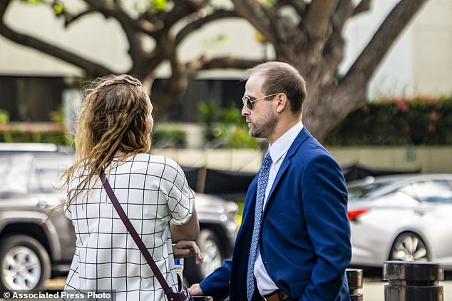 Stephen Tyler Bieneman, right, stands outside the federal courthouse, Monday, Nov. 6, 2023, in Honolulu.  (AP Photo/Mengshin Lin)