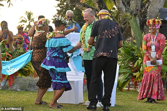 Australian Prime Minister Anthony Albanese dances before receiving a gift during a welcome ceremony at the Pacific Island Forum (PIF) in Aitutaki, Cook Islands,