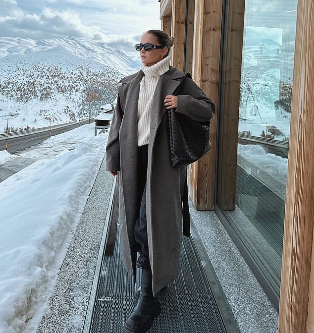 Stylish: In a second post, Molly-Mae posed outside in a large, cream turtleneck and a long, gray overcoat with black trousers and black boots