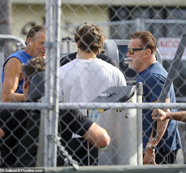 Bonding time: The father-son duo spent time together while using exercise equipment outside at the gym