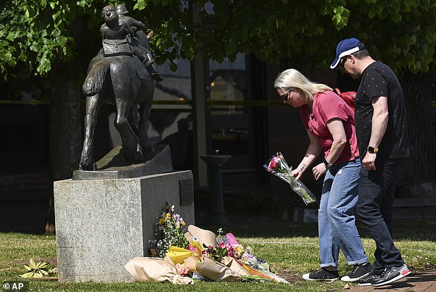 Mourners lay flowers outside the Royal Daylesford Hotel.  The beer garden was placed on the same grassy area as this statue