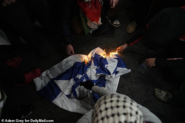 Pro-Palestinian protesters burned the Israeli flag in New York City at Columbus Circle on Friday evening