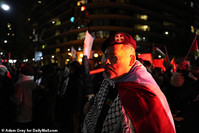 A protester is seen in Manhattan on Friday evening, draped in the Palestinian flag