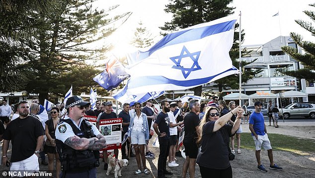 Escorted by police, the ride was largely uneventful until they reached Coogee, where nearly 100 protesters holding Israeli flags were waiting on the beach.