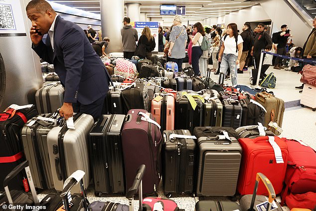 Travelers wait for their bags amid lines of unclaimed luggage in the United Airlines baggage claim area at Los Angeles International Airport on June 29, 2023 in Los Angeles, California