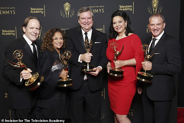 Haskell III (center) appears at the September 2021 Emmy Awards, winning Outstanding Television Movie for 'Dolly Parton's Christmas on the Square'