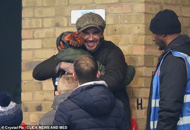 Sweet: After being spotted in the crowd, he greeted fans with a hug as they stopped for selfies with him