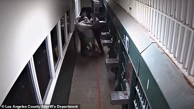 The two deputies slam his head into the wall outside his cell, while another deputy rushes in to help – despite the inmate not provoking the men in the clip