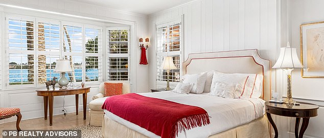 One of the seven bedrooms (pictured) is finished with small red accents, white walls and plenty of natural sunlight streaming through white blinds