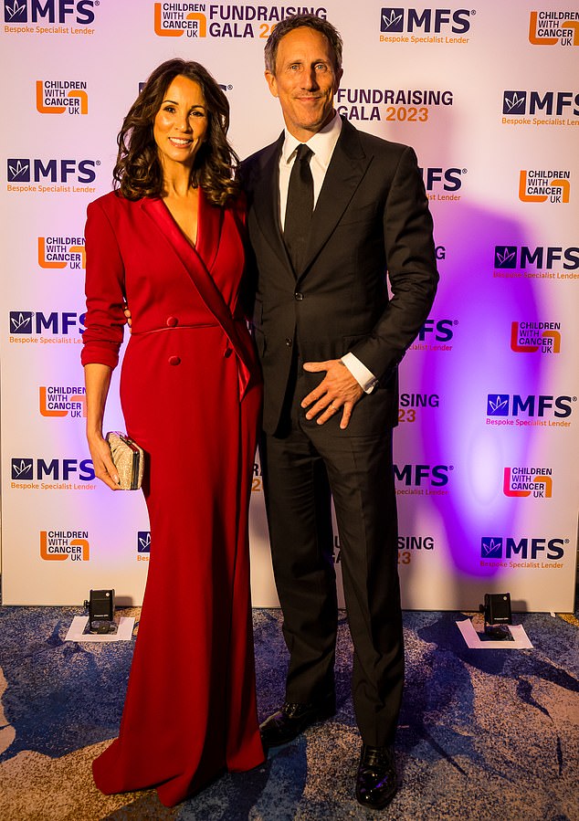 Gorgeous pair: Loose Ladies' Andrea McLean arrived in a suit-inspired red dress and her husband, businessman Nick Feeney, wore a black suit