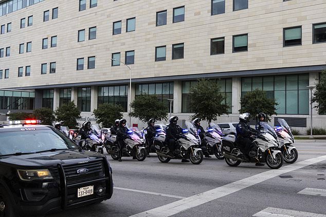 Austin Police Department officers prepare to ride in a procession leaving Dell Seton Medical Center in downtown Austin following the shooting of a police officer early Saturday