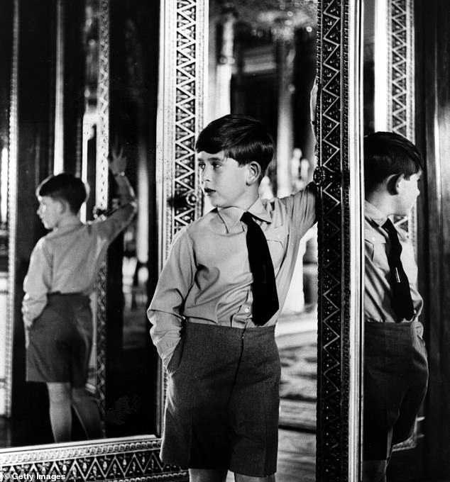 A young King Charles in one of the state rooms of Buckingham Palace on his eighth birthday