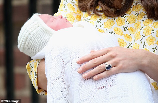 The ring is made of 18k white gold, with bright, brilliant 0.23k diamonds set in the band by Annoushka.  Pictured: Kate holding her daughter Charlotte in May 2015