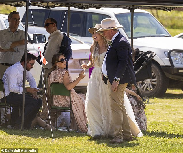 Some guests sat out of the sun, under a camping-style gazebo (pictured)