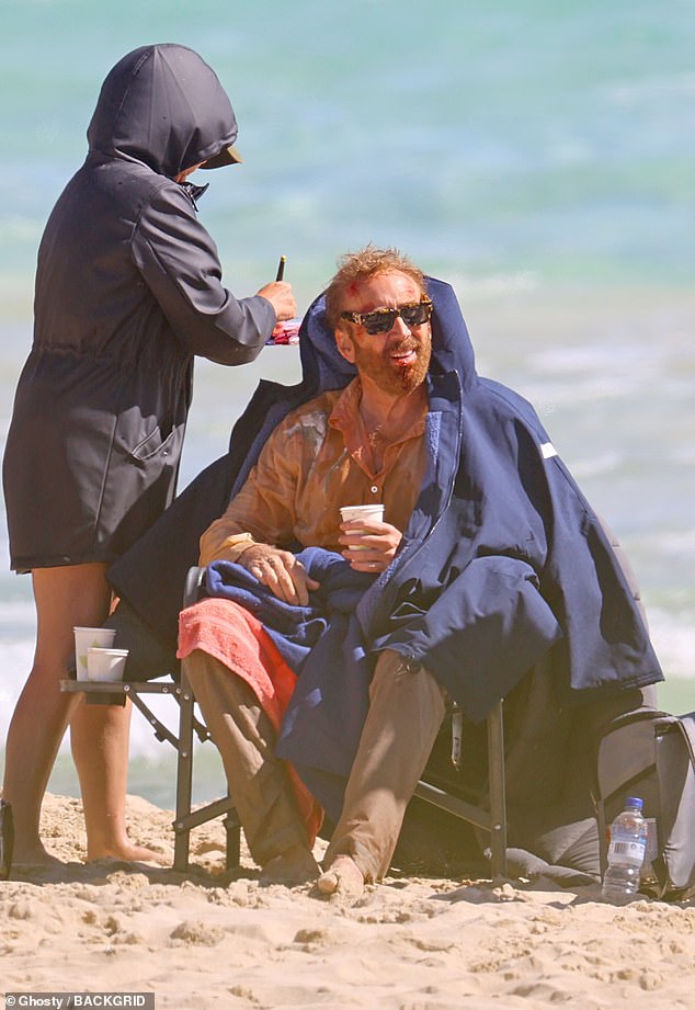 The Con Air star then enjoyed a well-deserved rest and a drink of water on a chair at the base of the plane, while donning a pair of stylish sunglasses to take in the scenic view.