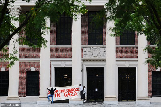 Pro-Palestinian protesters at Harvard put up a sign reading 'Stop the Genocide in Gaza'