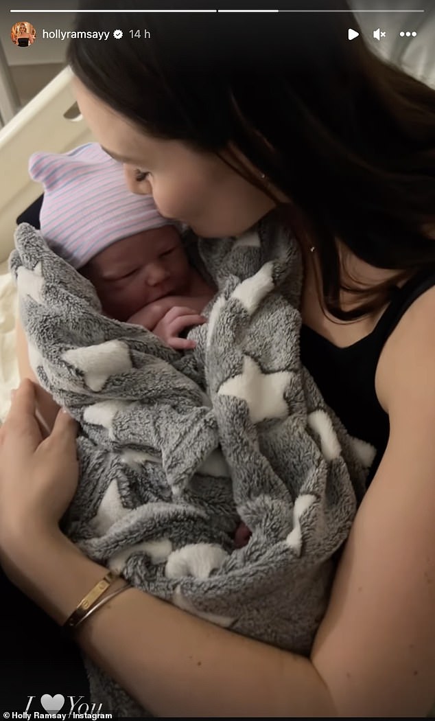 Cute: Holly also kissed Jesse while he was snuggled up in a little hat and cozy blanket