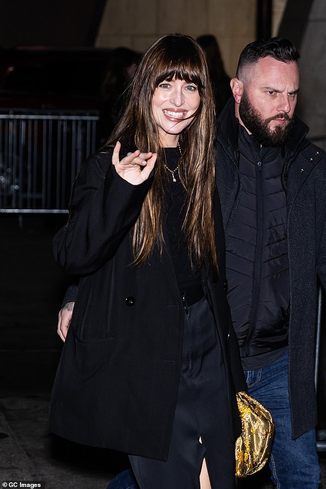 Chic: the actress donned a black T-shirt, layered with a short black jacket and accessorized with a trendy gold clutch bag