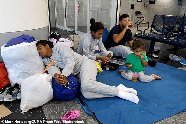 The Windy City is struggling with more than 11,000 migrants in shelters and 4,000 staying in police stations and O'Hare International Airport (photo)