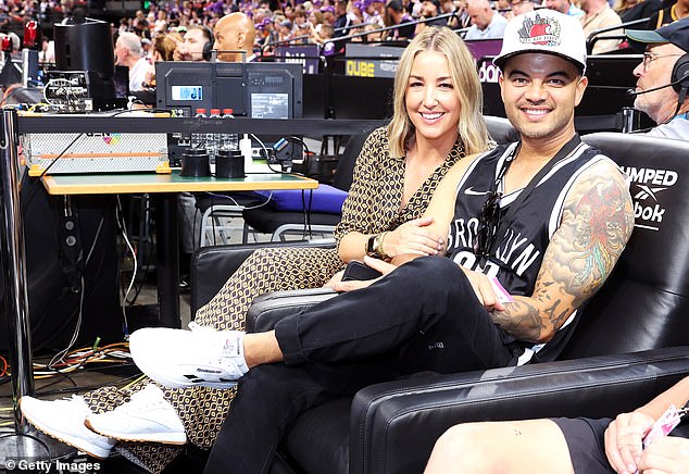 The singer and the stylist hugged on the pitch during the NBL match between Sydney Kings and the Brisbane Bullets at Qudos Bank Arena in Sydney