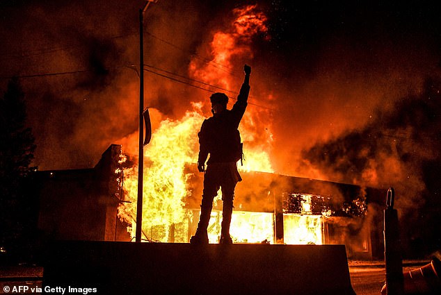 “Defund the Police,” which the expert is referring to, is the slogan uttered by liberals — especially in the wake of the 2020 protests — calling for the defunding of police departments across the country.  Pictured: A protester reacts while standing in front of a burning building that was set on fire during a demonstration in Minneapolis on May 29, 2020