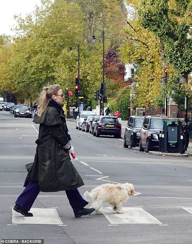 Out and about: Jodie dressed warmly with a navy blue scarf and a striped cream sweater, combined with black boots