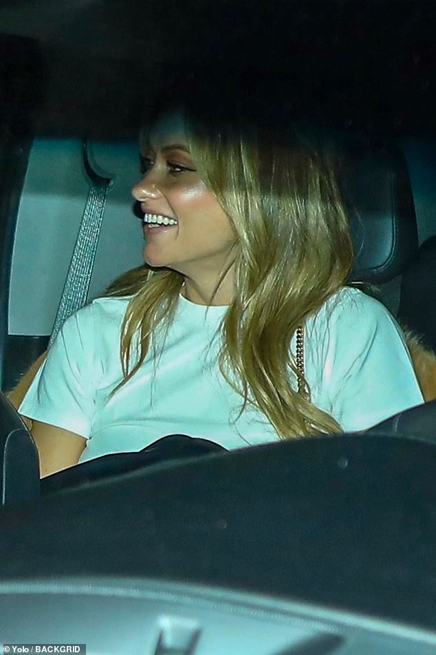 Her look: She wore a white crew-neck T-shirt and thin winged black liquid eyeliner while Chris sat in the back