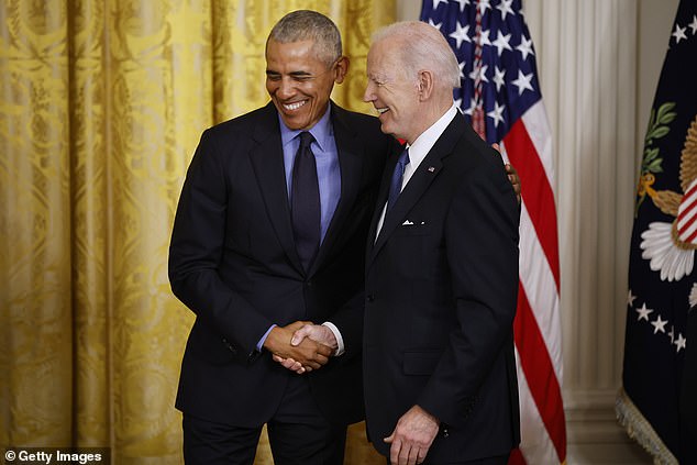 Former President Barack Obama and U.S. President Joe Biden shake hands in the East Room of the White House on April 5, 2022