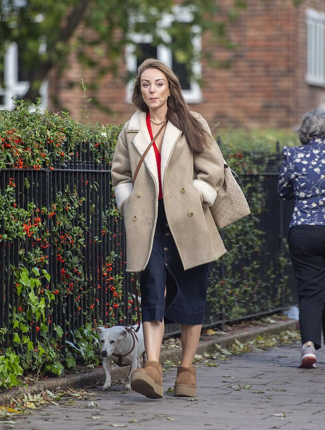 Looking good: she wrapped herself in a beige coat against the cold and wore a pair of comfortable brown platform boots