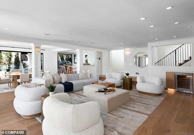 The main living area on the first floor features a wine cupboard and easy access to the kitchen