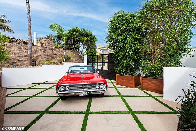 Billed as an 'enclosed motor court', the driveway is criss-crossed with grass and can accommodate up to three cars