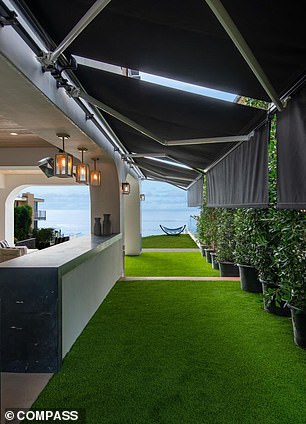 A lawn and artificial grass surround the pool and outdoor areas