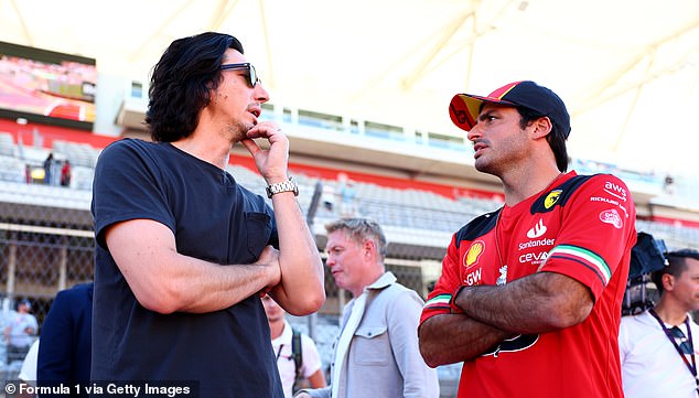 Adam Driver talks to Formula 1 Ferrari driver Carlos Sainz