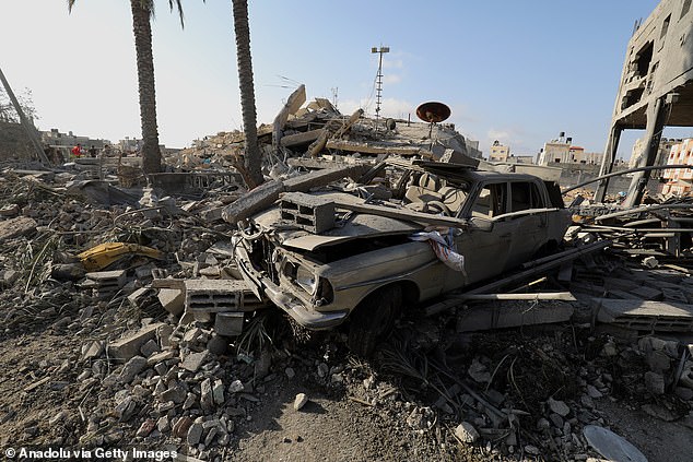 Civil protection teams and residents launch a search and rescue operation around the buildings destroyed after the Israeli attacks in Gaza (file photo)