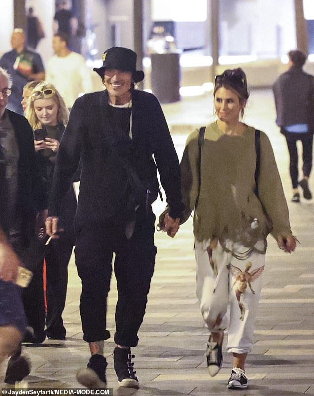 The Mötley Crüe drummer completed his look with a black hat and was joined by his wife Brittany (right) and son Brandon, whom he shares with ex Pamela Anderson