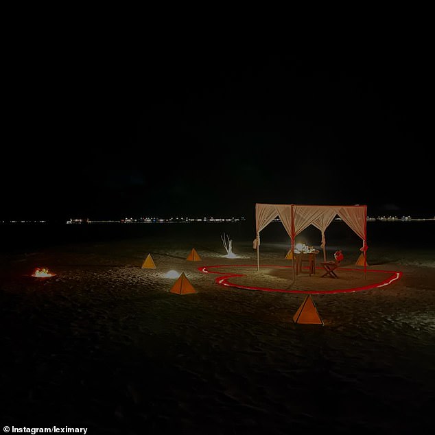 To capture the moment, the couple shared a photo of a secluded table on the beach, surrounded by a large love heart etched into the sand.