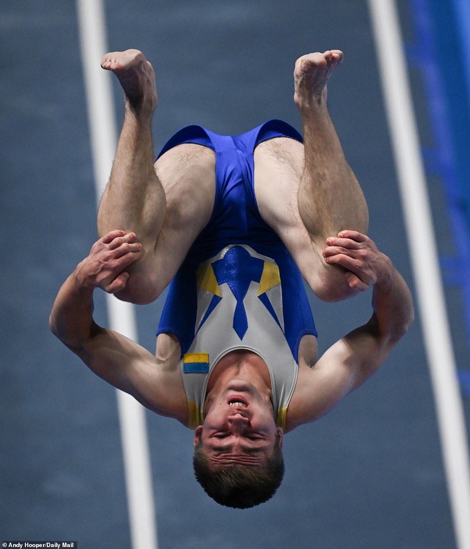 A Ukrainian competitor is pictured performing a somersault as he bids for a podium finish in the men's tumbling event