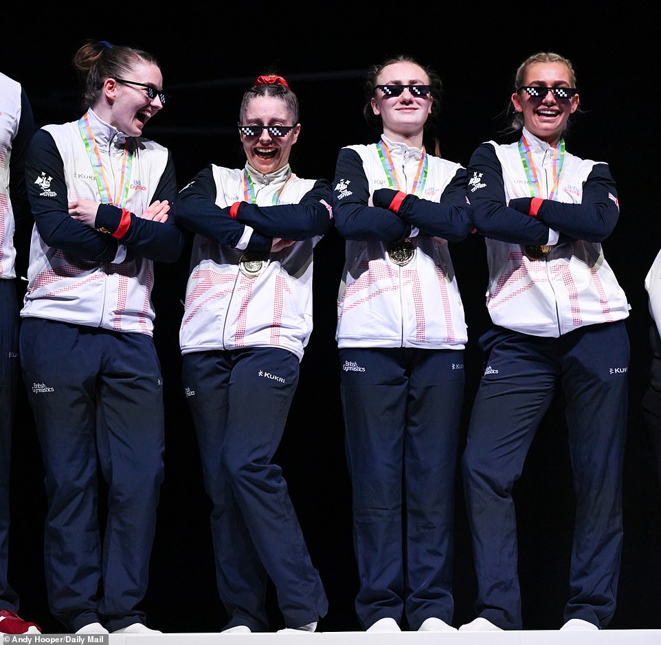 Ruth Shevelan, Kirsty Way, Molly McKenna and Bethany Williamson celebrate their team gold medal with pixelated glasses