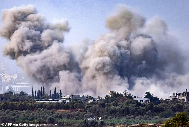 This photo taken from the Israeli side of the Gaza Strip border on November 11, 2023, shows smoke rising over buildings during an Israeli attack on the Palestinian enclave