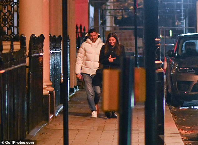 Sweet: The pair appeared in good spirits as they were pictured giggling close to each other in the street